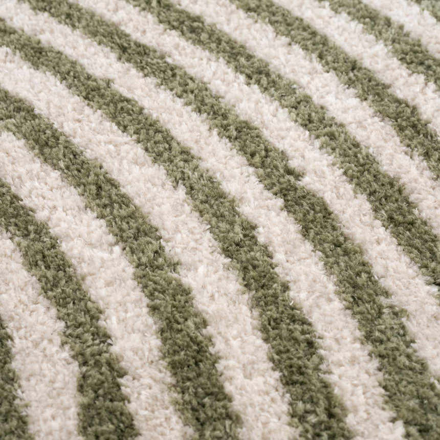 Close-up of the Allard Green Washable Area Rug, featuring a striped pattern in lime green and cream. Soft, textured polyester. Texture