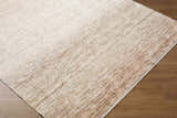 Close-up of the Amaury Area Rug, a farmhouse style rug in cream, dark brown, and medium gray on hardwood floor. Corner