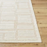 Close-up of the hand-woven Alayka Area Rug. Beige and light beige wool rug with a contemporary geometric pattern. Front
