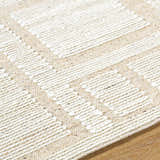 Close-up of the hand woven Alayka Area Rug. Beige and light beige wool with a contemporary geometric design. Texture