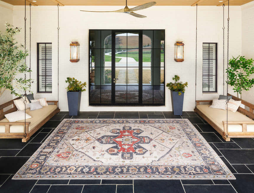 Covered patio with swing benches and Halayhayin Premium Rug in brick red, brown, and cream. Farmhouse style. Roomscene-Rectangle