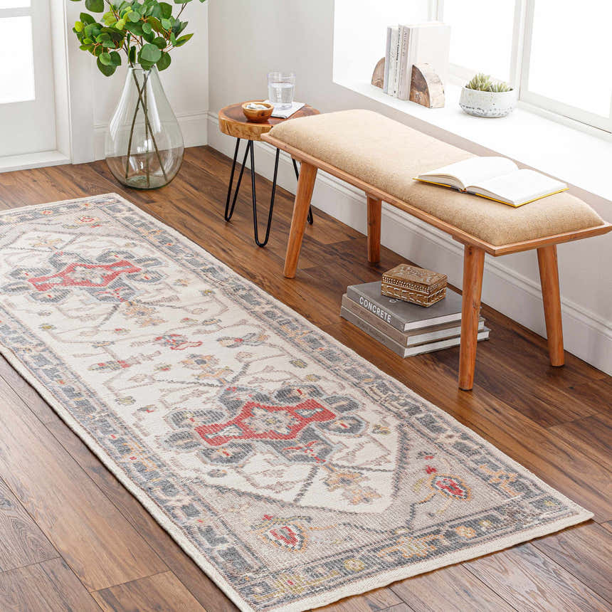 Hallway scene with a cream, brick red, and gray Halayhayin Premium Rug runner, wood bench, and hardwood floors. Roomscene-Runner