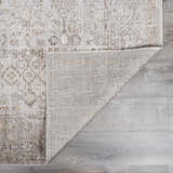 Close-up of Galey Alix x Livabliss Myrtle Avenue I Area Rug in taupe and cream, showing vintage oriental design and machine-woven texture. Fold