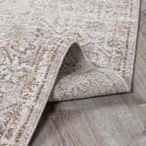 Close-up of Galey Alix x Livabliss Myrtle Avenue I Area Rug. Cream, taupe, and brown vintage oriental design. Fold