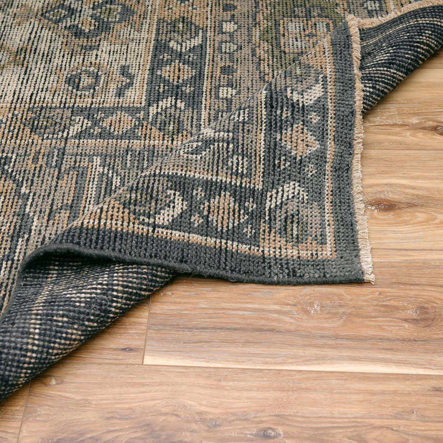Folded section of Huntspill Traditional Premium Wool Area Rug, displaying material thickness and weave. Traditional Area Rug Backing  
