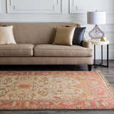 Living room scene with a tan sofa and the traditional Hobart Area Rug in brown, burgundy, and mustard tones. Roomscene-Rectangle