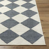 Close-up of Antho Handmade Vivir x LIVABLISS VVAT-2302 area rug. Ivory and slate gray diamond pattern, hand woven jute texture. Front
