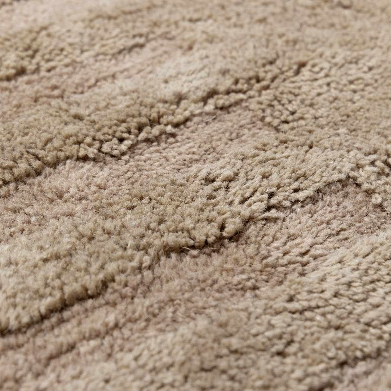 Close-up of the texture on Washable Handmade Wool Rug - Brown, showing fabric weave and feel. Contemporary, Broken Striped, Textured Area Rug Backing  2' x 3' Rectangle2'6" x 8' Runner3' x 5' Rectangle5' x 7'6" Rectangle6' x 9' Rectangle