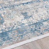 Close-up of the Hartsel Area Rug. Features a traditional pattern in charcoal, dark blue, gray, and mustard tones. Pile