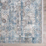 Close-up of the Hartsel Area Rug featuring a traditional pattern in charcoal, dark blue, gray, and mustard tones. Swatch