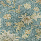 Close-up of Dalyn Luxury Hatay HY2 Teal Washable Area Rug. Floral pattern in beige, caramel, and muted sage on a teal background.