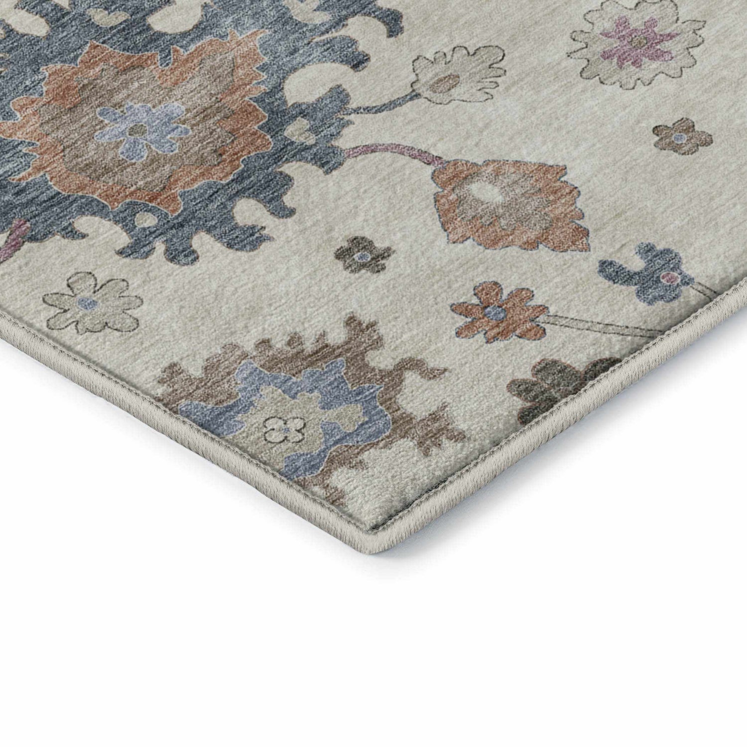 Close-up of the Dalyn Luxury Hatay HY4 Ivory Washable Area Rug featuring a traditional floral pattern in chestnut, coral, and blue.