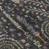 Close-up of Dalyn Luxury Hatay HY5 Black Washable Area Rug. Features floral and plant pattern in black, green, purple, and taupe.