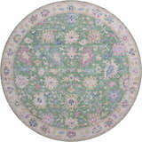 Close-up of a round Dalyn Luxury Hatay HY7 Lime Washable Area Rug with a lime green, floral pattern, and beige border.