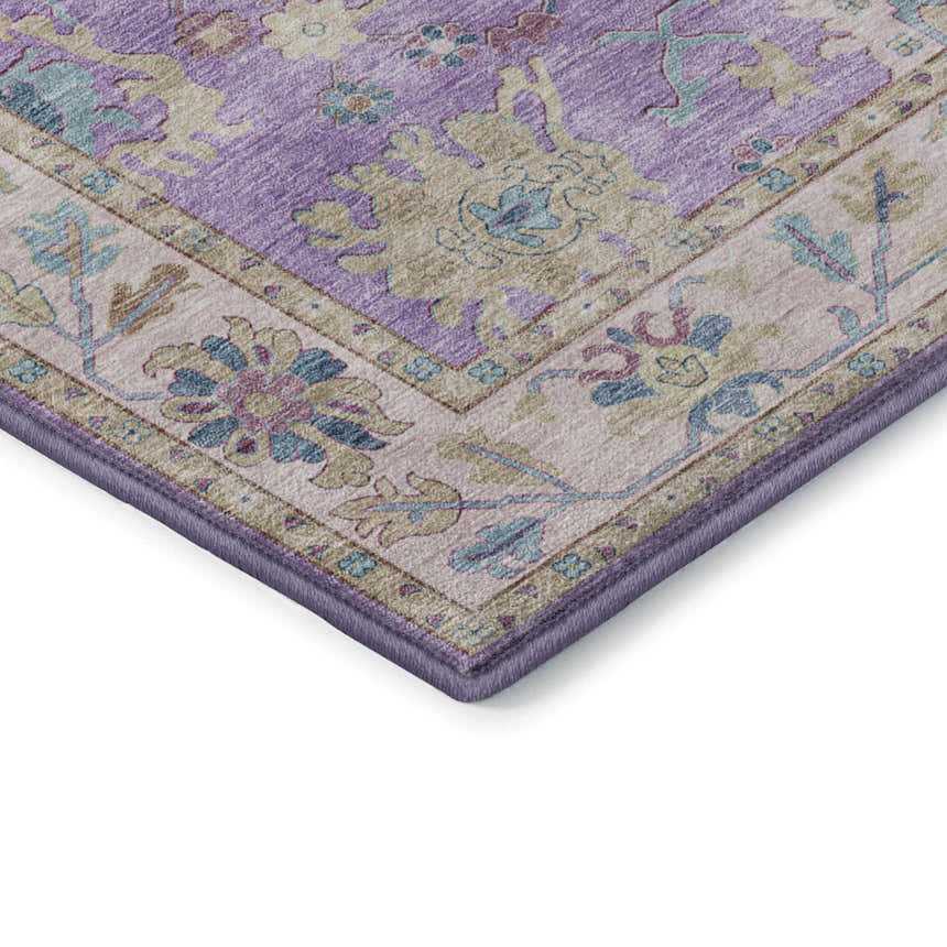 Close up of the Dalyn Luxury Hatay HY7 Purple Washable Area Rug showing a traditional floral pattern in purple, beige, and aqua.