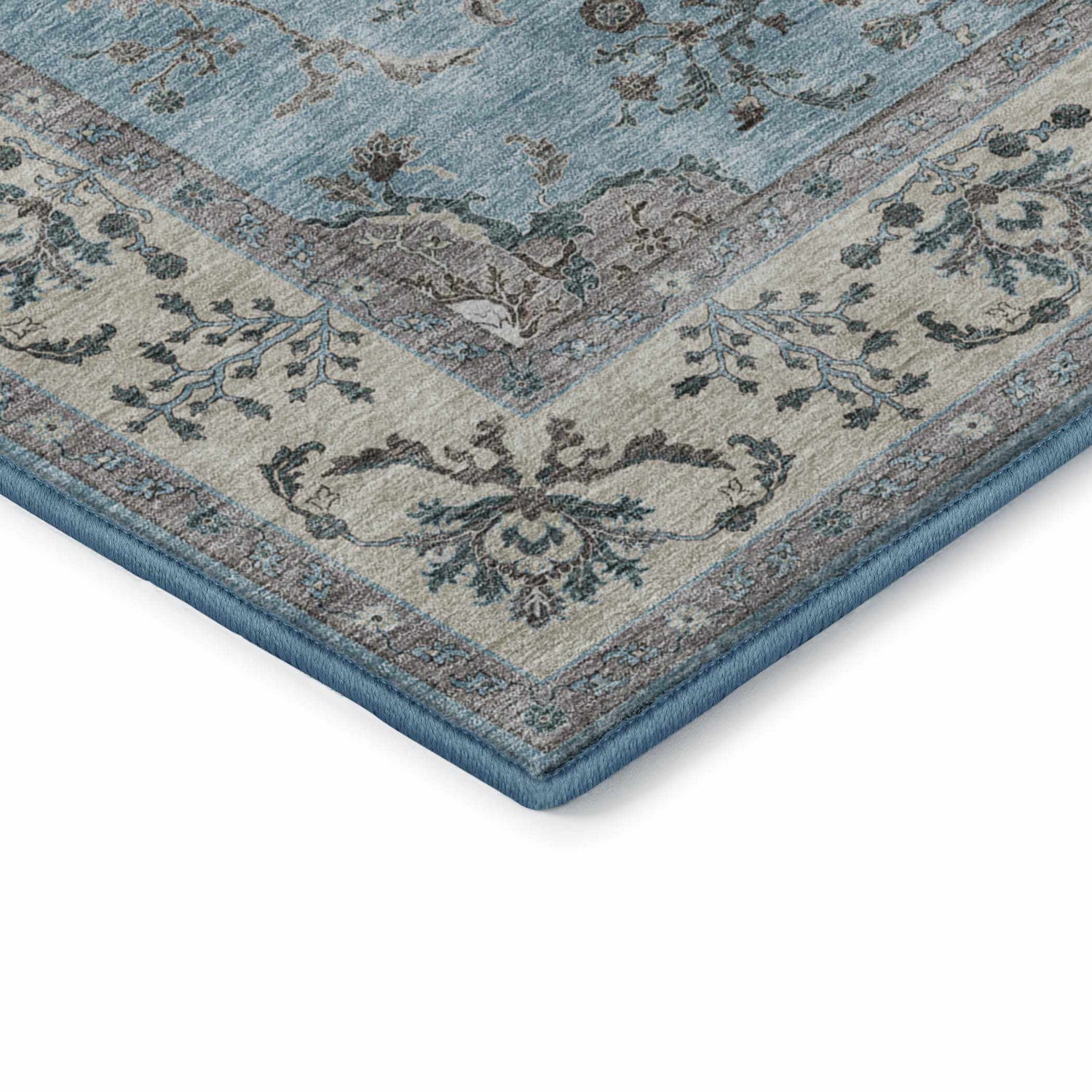 Close up of the corner of the Dalyn Luxury Hatay HY9 Sky Washable Area Rug. It features beige, light blue, and teal floral patterns.