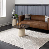 Living room with brown leather sofa and geometric New Whittington Area Rug in medium gray and off white. Roomscene-Rectangle