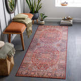 Entryway with Ichon Area Rug runner in brick red, charcoal, and cream, styled with a bench, plants, and decorative objects. Roomscene-Runner