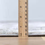 Close-up of Ironwood Textured Luxe Rug pile height, showing its construction and soft texture with a ruler for scale. Pile