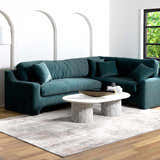 Living room scene with teal sectional sofa and Ironwood Textured Luxe Rug in charcoal, gray, light gray, medium brown, and taupe. Roomscene-Rectangle