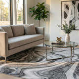 Living room scene with a gray sofa and the Itotia Marble Green Area Rug with a swirling marble pattern. Roomscene-Rectangle