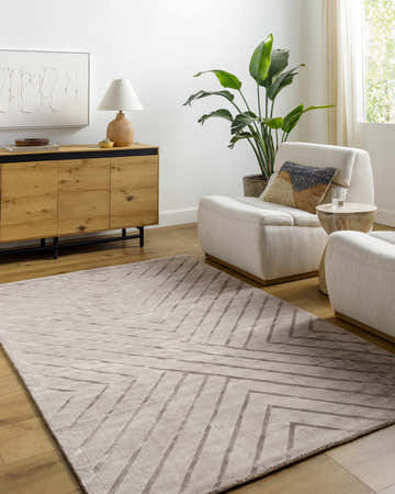 Living room scene with neutral armchairs and a Tavran Taupe subtle linear texture area rug. Roomscene-Rectangle