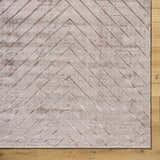 Close-up of Tavran Taupe rug showing subtle linear texture and farmhouse style on hardwood floor. Viscose, hand-loomed rug. Corner