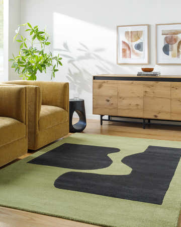 Living room scene with Arvok Olive Green rug, mustard chairs, wood cabinet, and abstract art for a contemporary aesthetic. Roomscene-Rectangle