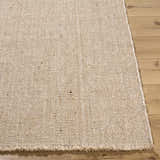 Close-up of the hand woven Cilaa Modern Wool Area Rug. Neutral color, textured weave, and fringed edge. Front