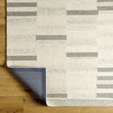 Close up of Livabliss Granada GND-2358 area rug. Hand-tufted wool rug with beige, cream, and medium gray geometric pattern. Fold