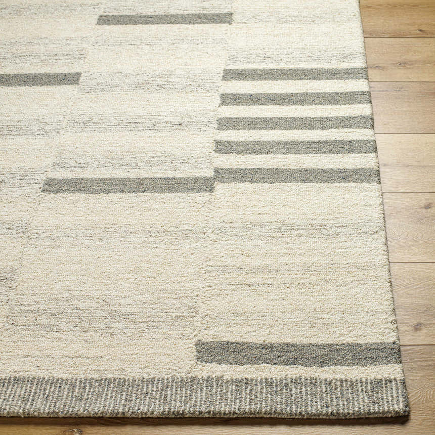 Close-up of Livabliss Granada GND-2358 area rug. Hand-tufted wool rug with beige, cream, and medium gray stripes and blocks. Front