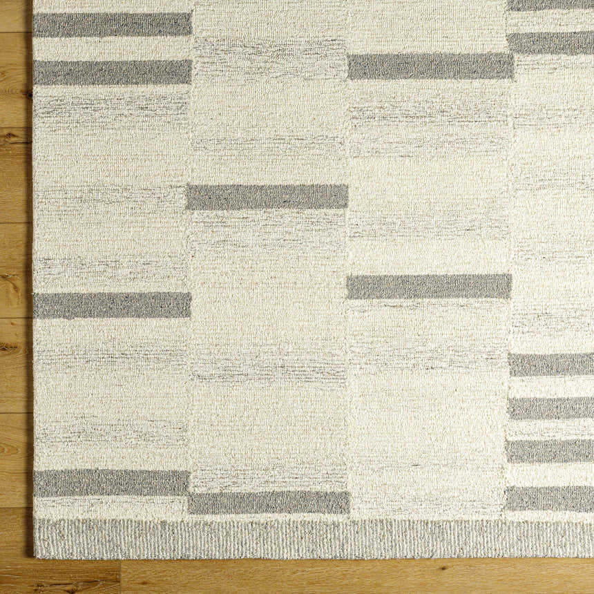 Close up of the Livabliss Granada GND-2358 rug. Hand tufted wool rug in beige, cream, and medium gray with a geometric pattern. Corner