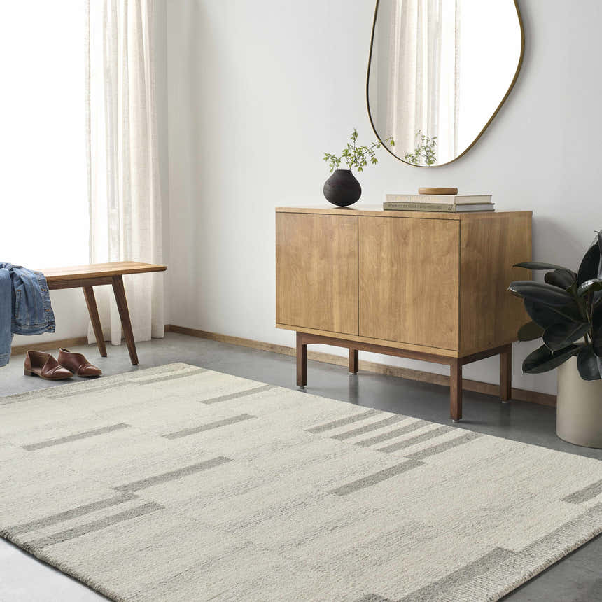 Entryway with Livabliss Granada GND-2358 rug, wood cabinet, bench, and mirror. Beige, cream, and gray tones. Roomscene-Rectangle