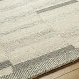 Close-up of the Livabliss Granada Surya GND-2358 area rug. Beige, cream, and gray wool rug with a textured, geometric pattern. Texture