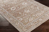 Close-up of the Kaongkod Area Rug - Clearance showing its traditional, floral pattern and dusty pink, ivory, and brown colors. Corner