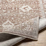 Close-up of the Kaongkod Area Rug showing its dusty pink, ivory, and brown traditional pattern and machine-woven construction. Fold