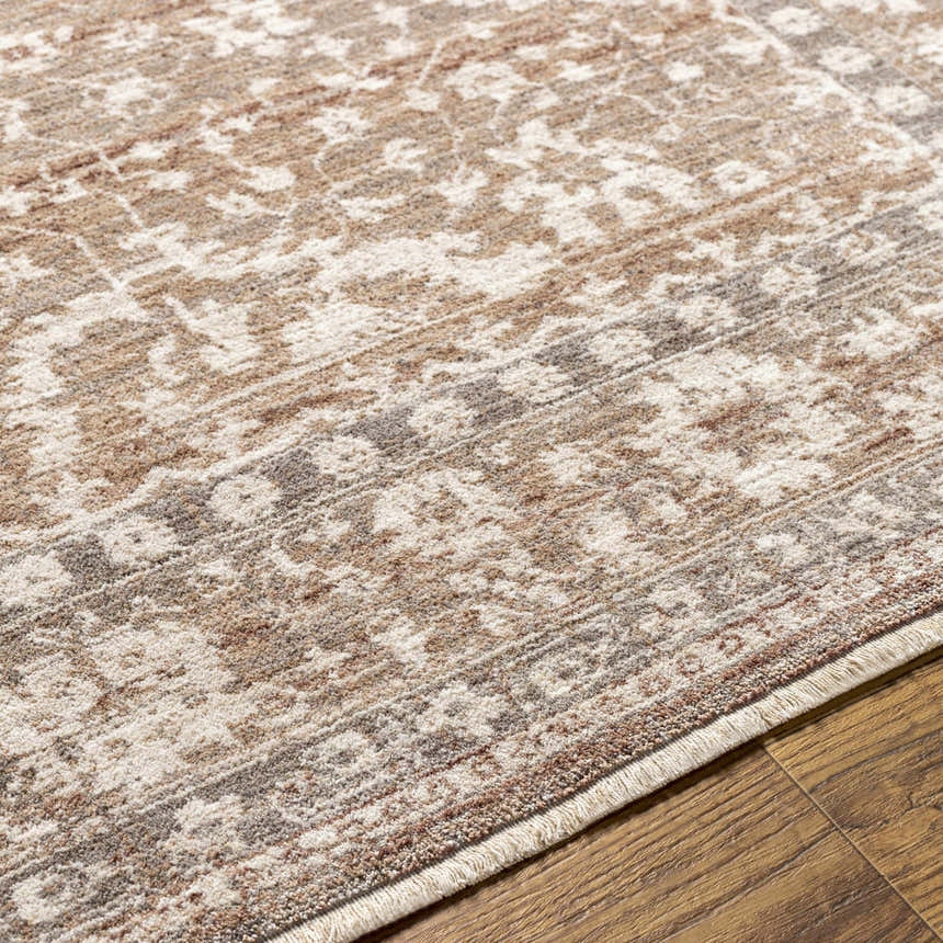 Close-up of the Kaongkod Area Rug. Farmhouse style rug in dusty pink, ivory, and brown with a traditional pattern. Texture