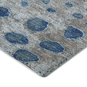 Close-up of the Dalyn Luxury Kochi KC13 Gray Area Rug. Features a gray background with denim and navy abstract spots.