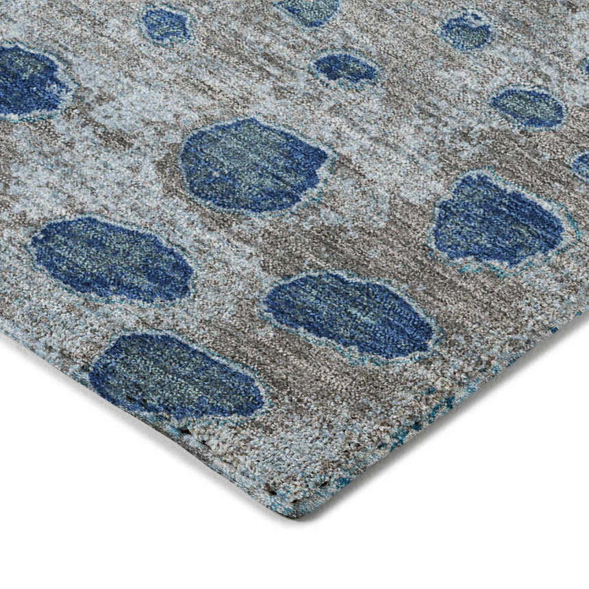 Close-up of the Dalyn Luxury Kochi KC13 Gray Area Rug. Features a gray background with denim and navy abstract spots.