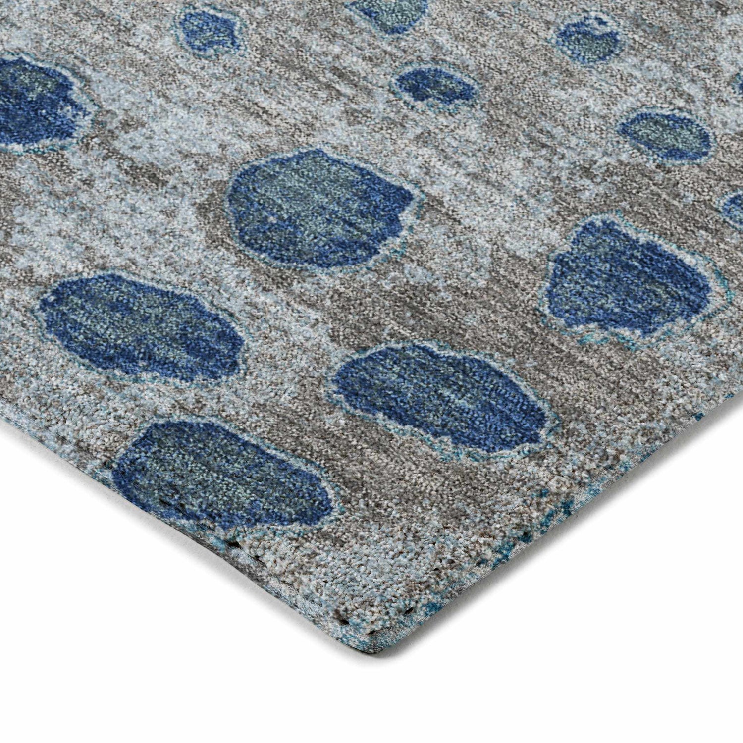 Close-up of the Dalyn Luxury Kochi KC13 Gray Area Rug. Features a gray background with denim and navy abstract spots.