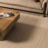 Living room scene with a neutral sofa and Kayoko Ivory Area Rug. Roomscene-Rectangle