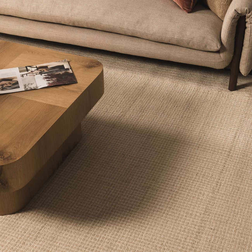 Living room scene with a neutral sofa and Kayoko Ivory Area Rug. Roomscene-Rectangle