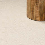 Close up of the ivory Kayoko Area Rug showing subtle herringbone pattern and wool texture. Styleshot