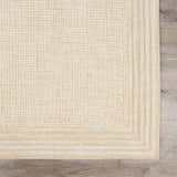 Close up of the ivory Kayoko Area Rug showing its textured, grid-like pattern and hand-tufted wool. Swatch