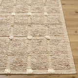 Close-up of the hand woven Keegan Area Rug. Beige, sandstone, and taupe wool with a textured geometric pattern. Front