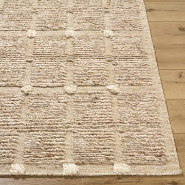 Close-up of the hand woven Keegan Area Rug. Beige, sandstone, and taupe wool with a textured geometric pattern. Front