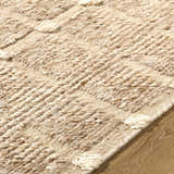 Close up of the hand woven Keegan Area Rug, showing beige, sandstone, and taupe wool texture and pattern. Texture