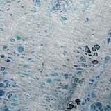 Close-up of Dalyn Machine Kikiamo KK18 Ocean Washable Area Rug. Features light blue, ocean, teal, and taupe abstract pattern.