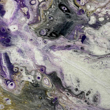 Close-up of the Dalyn Machine Kikiamo KK7 Majesty Washable Area Rug featuring a contemporary chestnut, gold, and purple pattern.