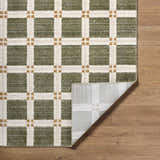 Close-up of Kalkin Olive Area Rug featuring a contemporary olive, cream, and gold grid pattern on a wood floor. Fold
